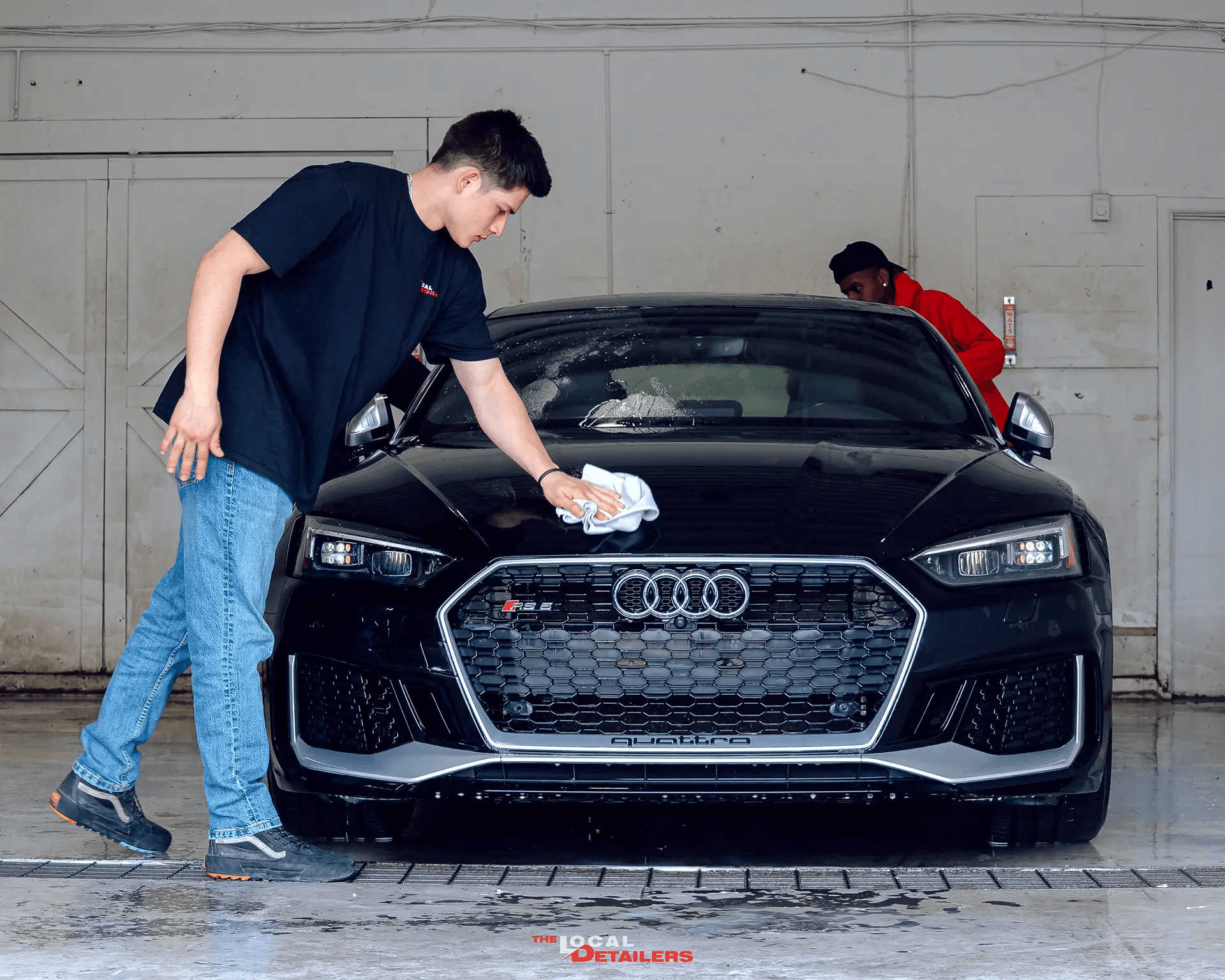 The Local Detailers technicians hand-drying a black Audi after a wash