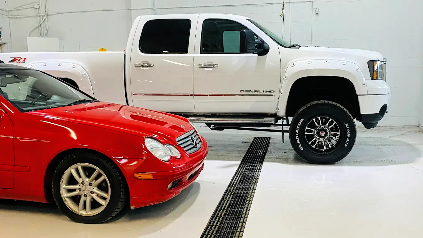 Vehicles parked inside The Local Detailers' 36 Ave SE studio bay